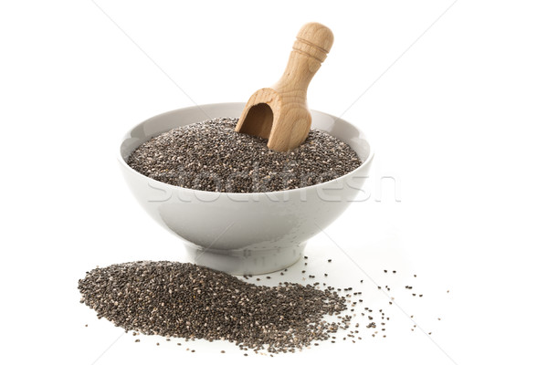 Raw, unprocessed, dried black chia seeds in white bowl with wood Stock photo © ShawnHempel
