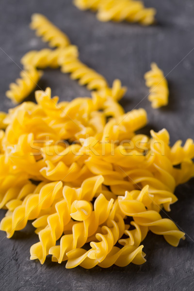Heap of dried raw, uncooked spirelli pasta noodles Stock photo © ShawnHempel