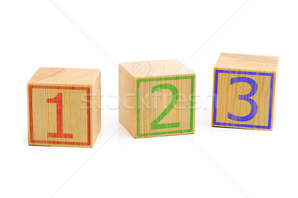Three brown wooden cubes lined up in a row with numbers one, two Stock photo © ShawnHempel