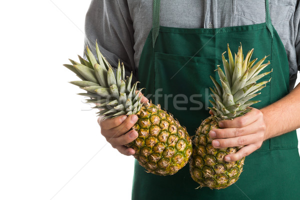 Farmer holding whole fresh pineapple fruit Stock photo © ShawnHempel