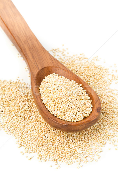 Raw, uncooked, whole quinoa seed in wooden spoon Stock photo © ShawnHempel
