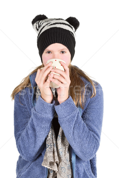 Stock photo: Young girl with jacket and wooly hat holding cup 