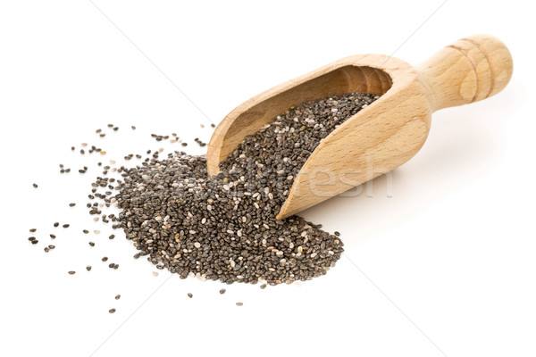 Whole dried black chai seeds in wooden scoop Stock photo © ShawnHempel