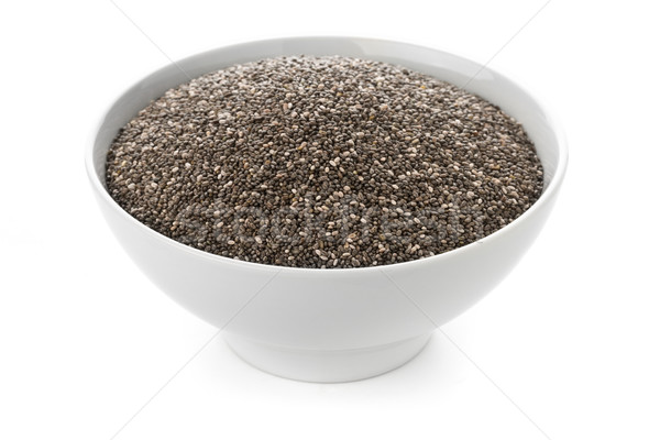 Raw, unprocessed, dried black chia seeds in white bowl on white  Stock photo © ShawnHempel
