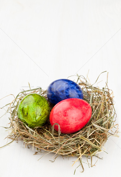 Ovos de páscoa feno ninho branco madeira vermelho Foto stock © ShawnHempel