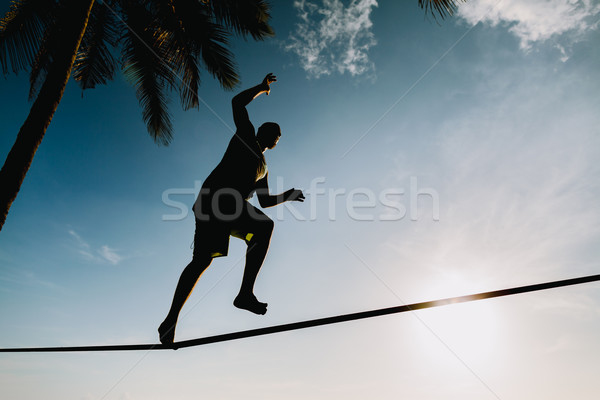 teenage balancing on slackline with sky view Stock photo © shevtsovy