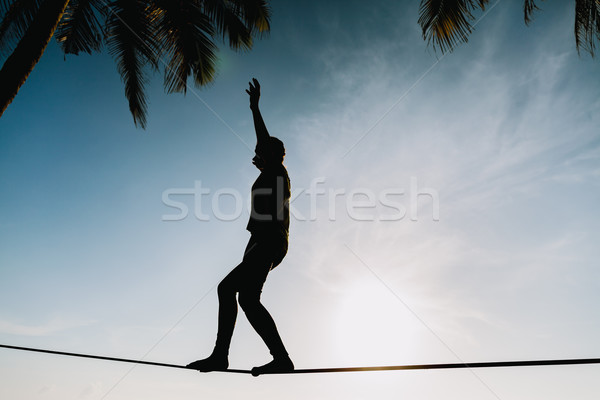 teenage girl  balancing on slackline with sky view Stock photo © shevtsovy