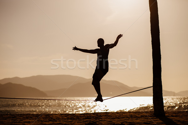 teenage balancing on slackline with sea view Stock photo © shevtsovy