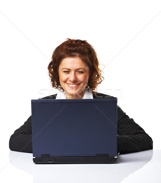 A Happy successful business woman smiling while working on lapto Stock photo © shyshka