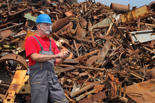 Recycling industry, heap of old metal and worker Stock photo © simazoran