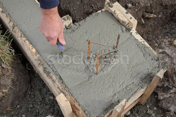 Construction worker making concrete foundation in formwork Stock photo © simazoran