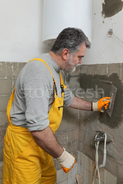 Home renovation, mason fixing wall Stock photo © simazoran