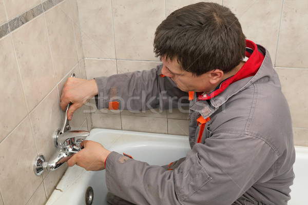 Plumber works in a bathroom Stock photo © simazoran