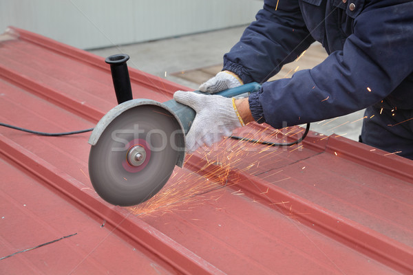 Worker using angle grinder, construction site Stock photo © simazoran