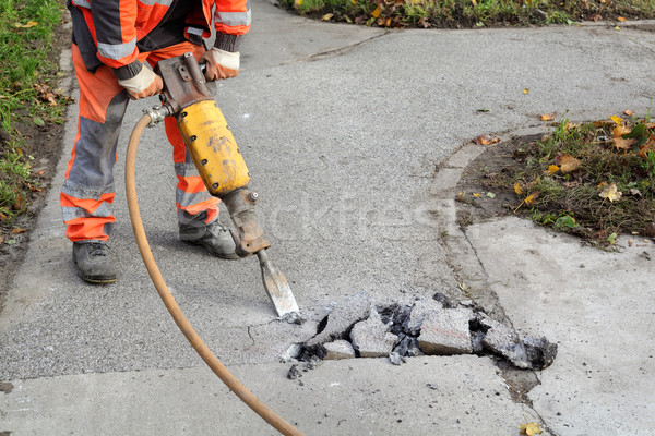 Asphalt demolishing, worker and jackhammer Stock photo © simazoran