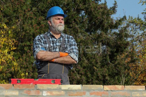 Stock photo: Worker examining brick wall