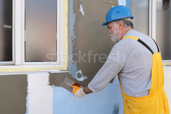 Ház rendbehoz fal szigetelés munkás kéz Stock fotó © simazoran