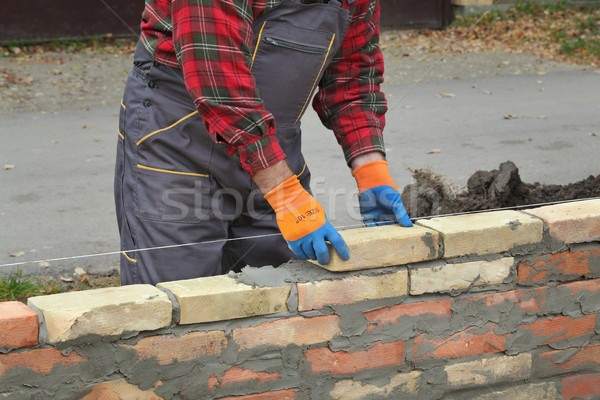 Worker building brick wall Stock photo © simazoran