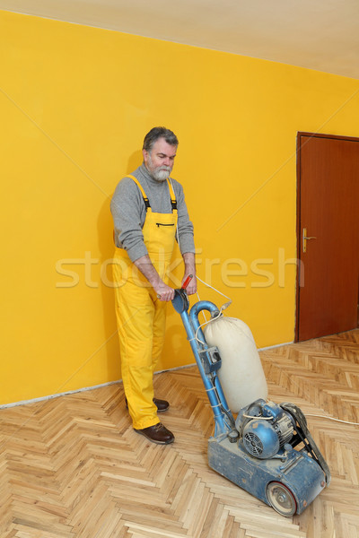 Home renovation, worker sanding parquet Stock photo © simazoran