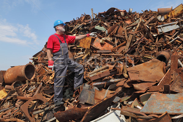 Recycling industry, worker gesture at heap of old metal Stock photo © simazoran