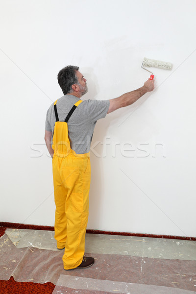 Worker painting wall in room Stock photo © simazoran