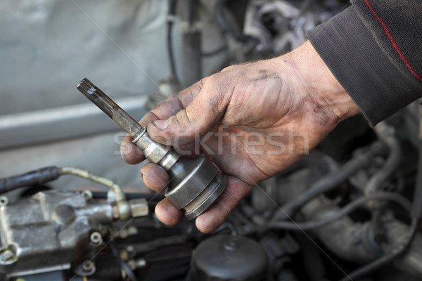 Stock photo: Car mechanic hold spanner socket driver tool  in hand