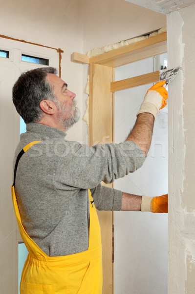 Construction site, worker installing gypsum board Stock photo © simazoran