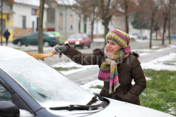 Automotive, woman remove snow from a car Stock photo © simazoran