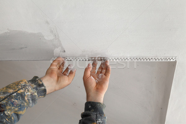 Worker install batten at ceiling and wall Stock photo © simazoran