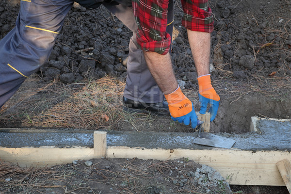 Construction worker making concrete foundation in formwork Stock photo © simazoran