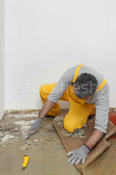 Worker using putty knife for cleaning floor Stock photo © simazoran