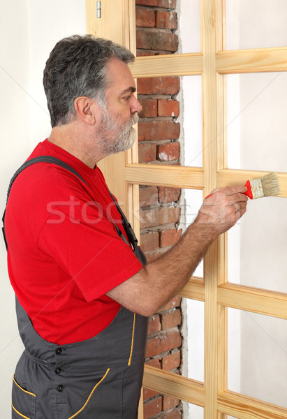 Home renovation, worker painting wooden door, varnishing  Stock photo © simazoran