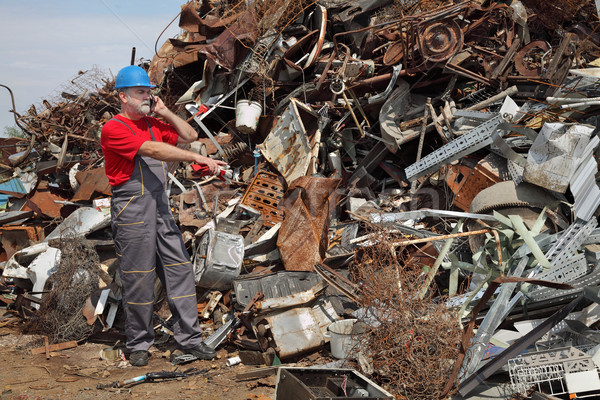 Recycling industry, worker using phone and pointing Stock photo © simazoran