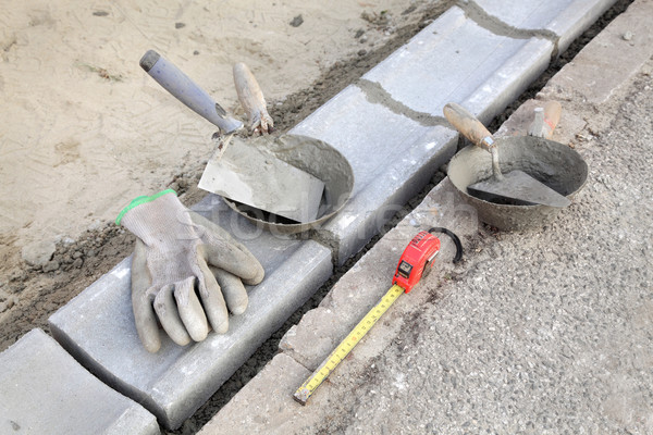 Construction site, curb stone and mason tools Stock photo © simazoran