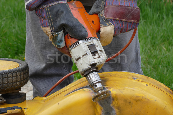 Worker brushing metal with power tool Stock photo © simazoran