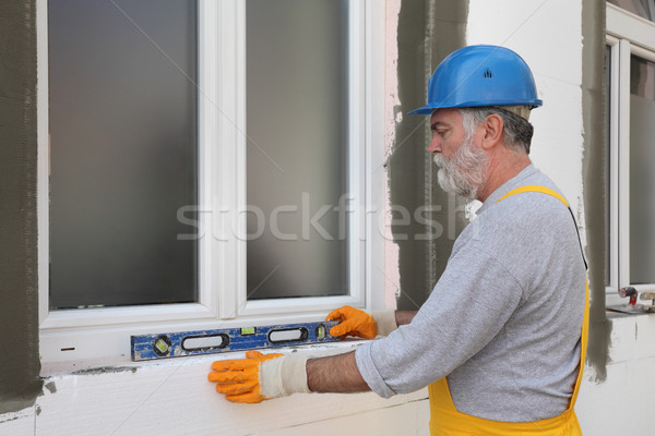 Stock photo: House renovation, polystyrene wall insulation, level tool