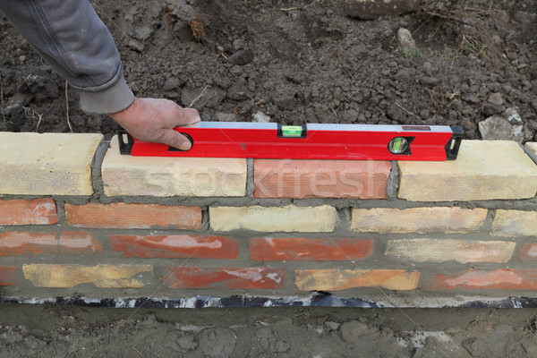 Stock photo: Worker building brick wall
