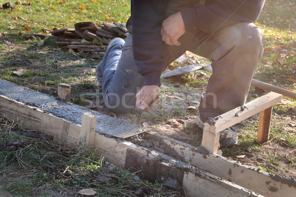 Construction worker making concrete foundation in formwork Stock photo © simazoran