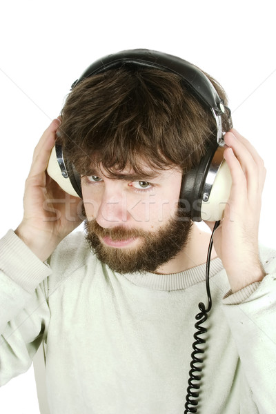 Scettico musica giovane guardando ascoltare musica cuffie Foto d'archivio © SimpleFoto