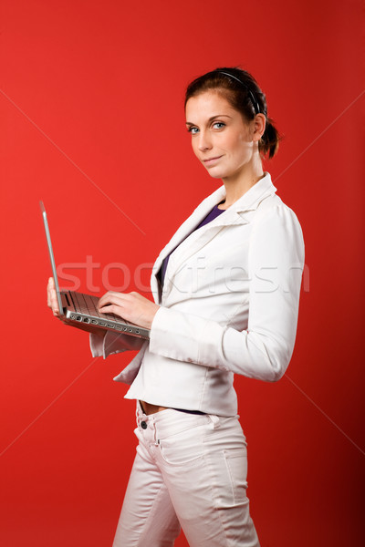 Stock photo: Female with Computer on Red