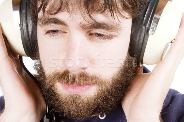 Muzyki młodych mężczyzna broda słuchanie muzyki słuchawki Zdjęcia stock © SimpleFoto