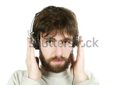 Cético música moço olhando ouvir música fones de ouvido Foto stock © SimpleFoto