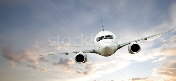 Avião vôo pôr do sol céu azul voar Foto stock © SimpleFoto