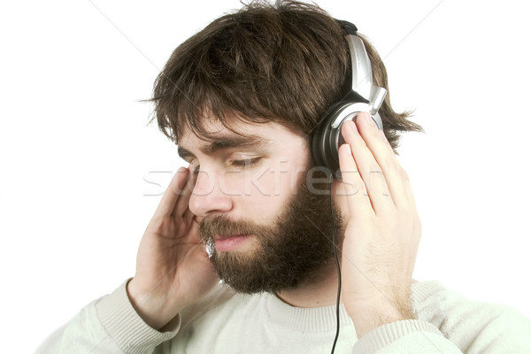 Muzyki młodych mężczyzna broda słuchanie muzyki słuchawki Zdjęcia stock © SimpleFoto