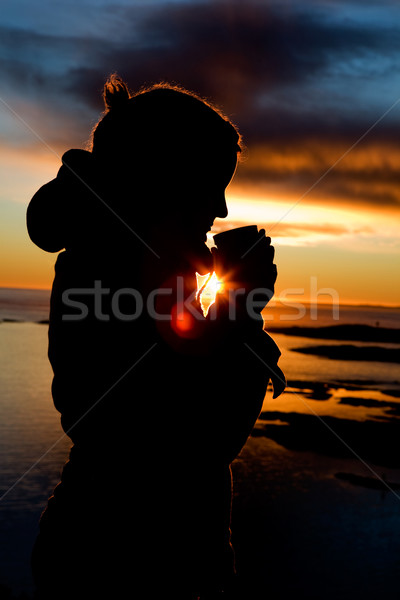 Ocean sylwetka osoby stałego pić ciepły Zdjęcia stock © SimpleFoto