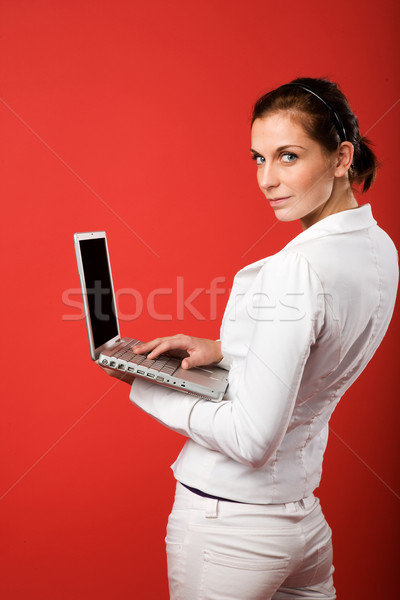 Female with Computer on Red Stock photo © SimpleFoto