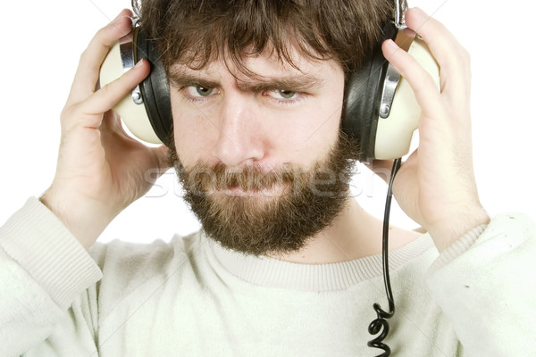 Sceptisch muziek jonge man naar luisteren naar muziek hoofdtelefoon Stockfoto © SimpleFoto