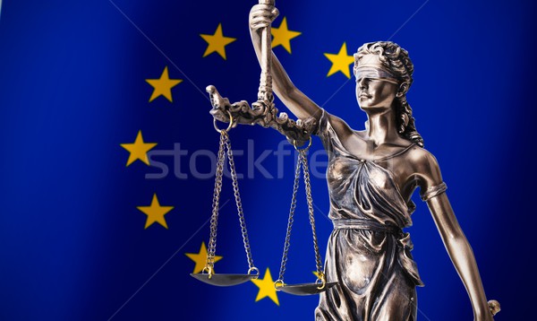 Themis with scale, symbol of justice on European Union flag back Stock photo © simpson33