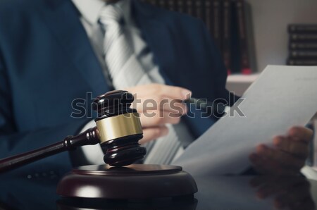 Stock photo: Wooden gavel, working lawyer in background