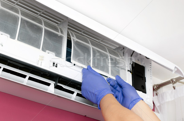 Air conditioner cleaning. Man checks the filter. Stock photo © simpson33